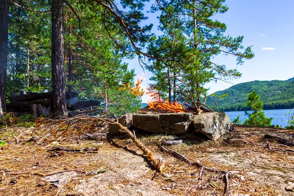 Fishermen\'s camp on the island with a bonfire. Lake Tagasuk. Krasnoyarsk Territory, Siberia, Russia