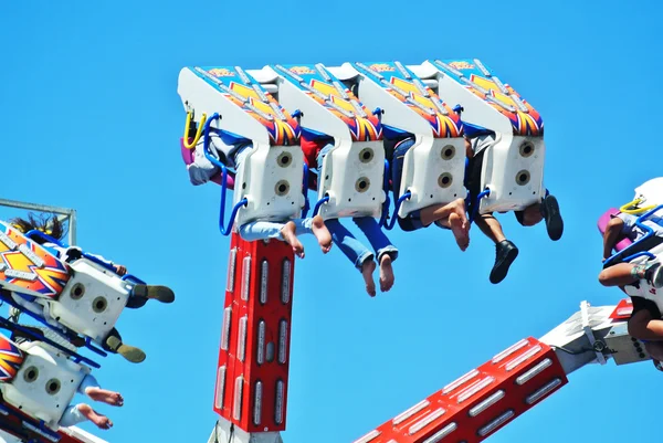 People enjoying an exciting carnival ride — Stock Photo, Image