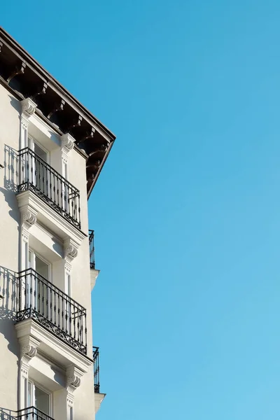 Minimal corner of classy building with windows and balconies downtown of Madrid, Spain.