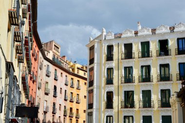 Classy renaissance aged buildings on the other side of Plaza Mayor under vivid sky downtown Madrid, Spain