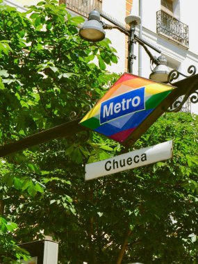 Metro sign of Chueca metro station in gay friendly district downtown Madrid at summertime clipart