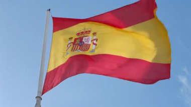 Madrid şehir merkezinde güneşli bir günde hafif rüzgârda dalgalanan İspanyol bayrağının görüntüsü