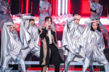 Chinese singer, dancer and actor Jackson Yee, middle, sings a song during the 2020 Tmall Double 11 Gala held by Alibaba Group in Shanghai, China, 10 November 2020. clipart