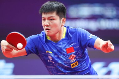 Chinese table tennis player Fan Zhendong plays against Chinese table tennis player Ma Long at the mens final of 2020 ITTF Finals in Zhengzhou city, central China's Henan province, 22 November 2020  clipart