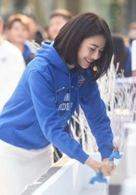 Chinese actress Gao Yuanyuan attends a charity campaign by the West Lake, she cleans her hands by using cold water during the cold winter, calling the public's attention to poor children's hygiene issues in Hangzhou City, east China's Zhejiang Provin clipart