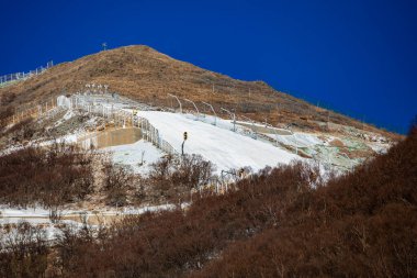 Photos show the National Alpine Skiing Center, the site of the Beijing Winter Olympics at Xiaohaituo Mountain in Yanqing District, Beijing, China, 11 January 2021. It passes the site inspection certification of the International Snow Federation and i clipart