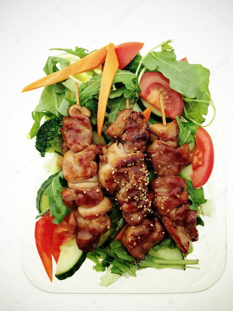Chicken skewers with salad