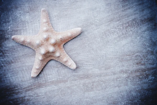 Starfish on old wood background — Stock Photo, Image