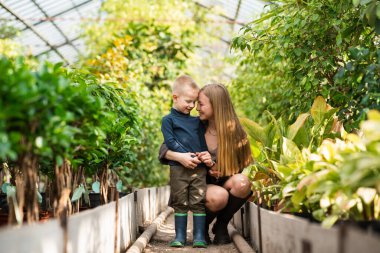 Mutlu anne serada yürürken oğluna sarılıyor.