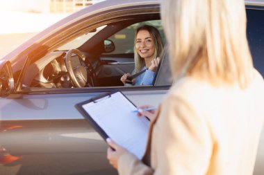 Eğitmen Not Alırken Genç Öğrenci Sürücü Emniyet kemerini Ayarlıyor