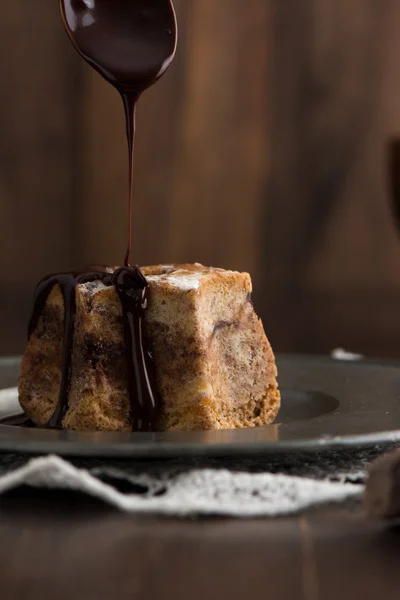 Close-up of cake with dark chocolate pouring — Stock Photo, Image
