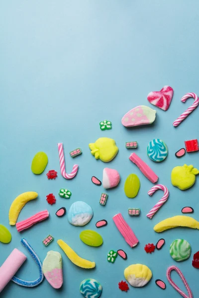 Mixed collection of colorful candy, on blue background — Stock Photo, Image