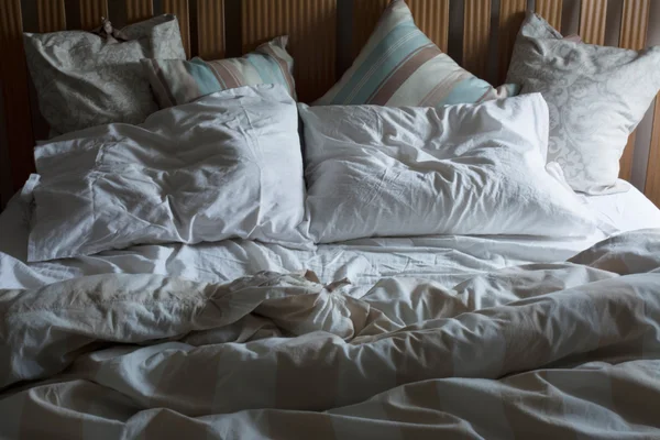 Double bed unmade, with the morning light — Stock Photo, Image