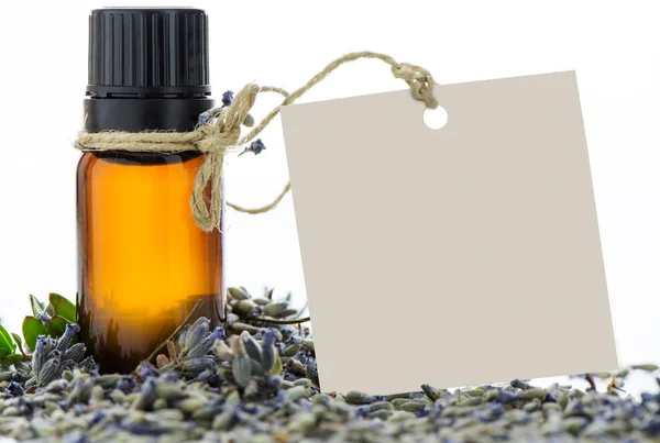 Essential oil, empty tags and lavender flowers — Stock Photo, Image