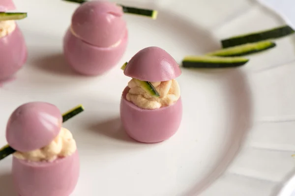 Deviled quail eggs with cream cheese, dyed with beet juice. — Stock Photo, Image