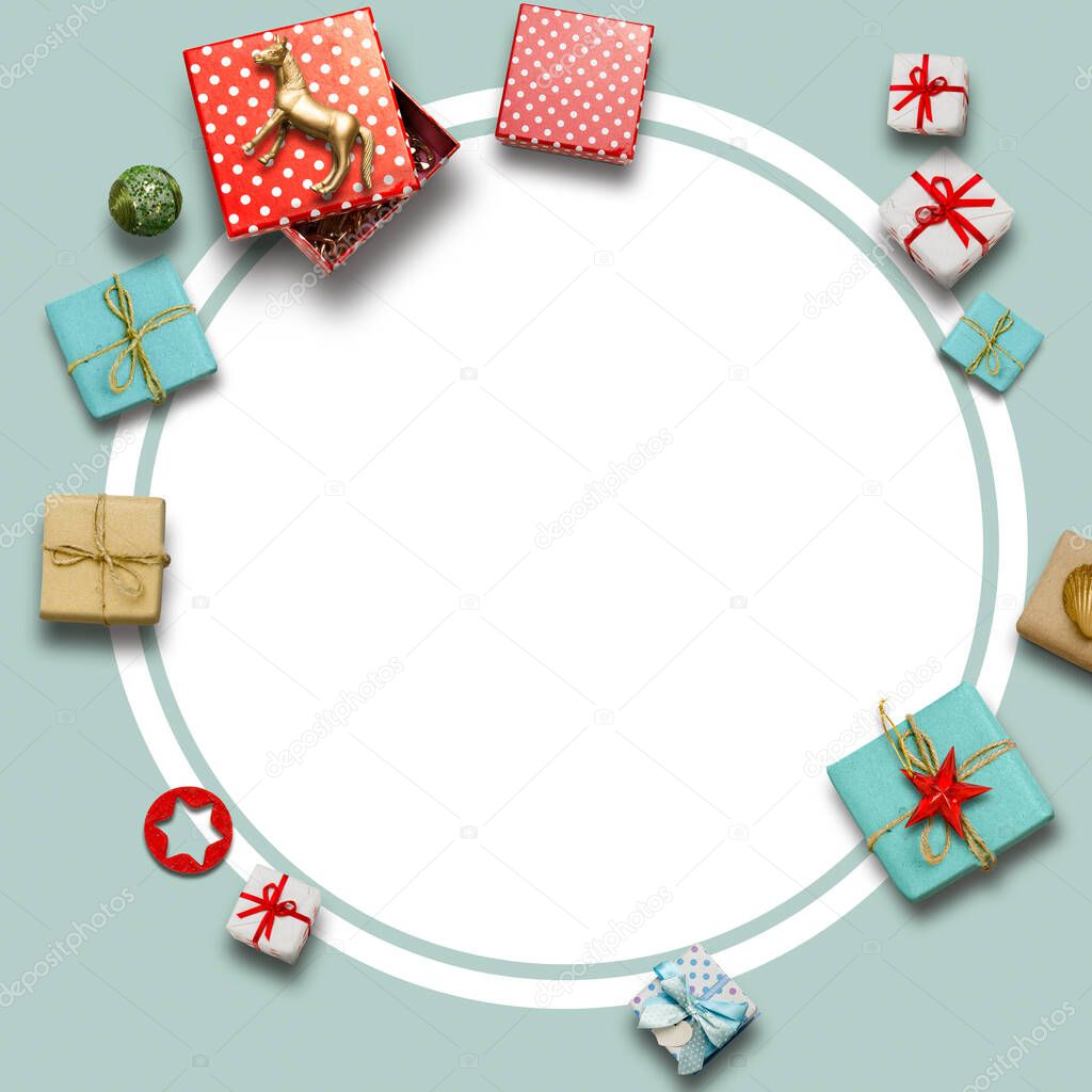 Christmas round frame holiday, surrounded by wrapped gifts on a light blue background. Christmas shopping concept