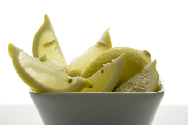 Lemons cut into square bowl, white background — Stock Photo, Image