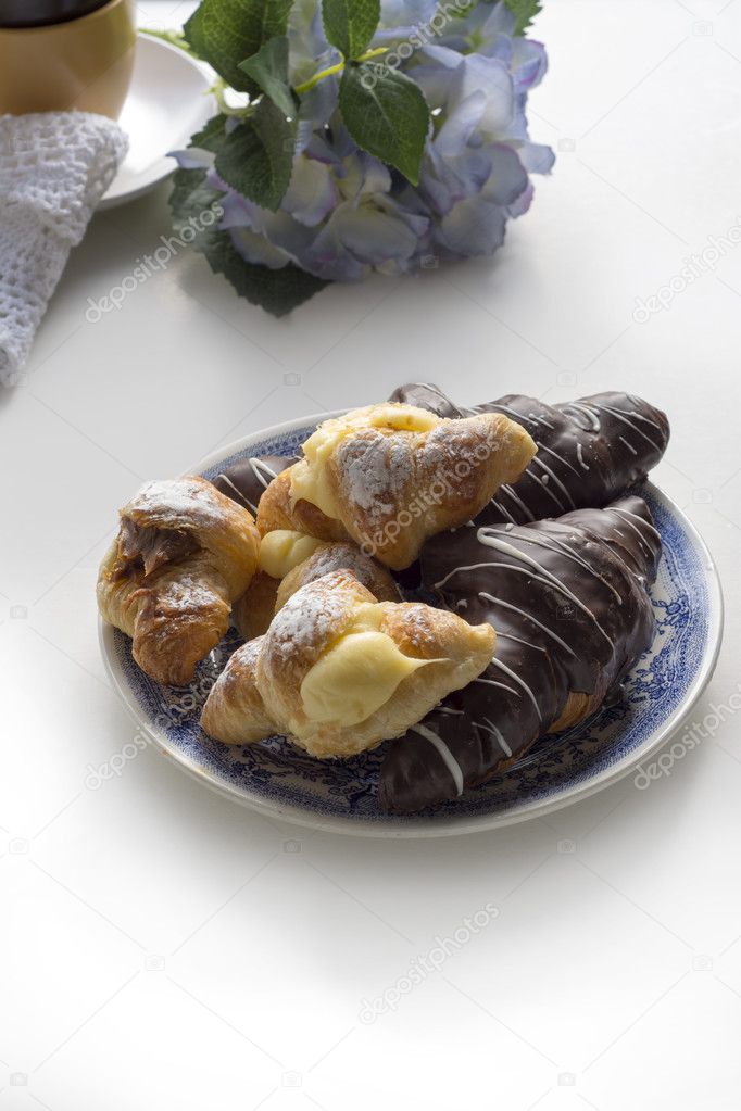 Croissant covered with chocolate and filled with cream and caram