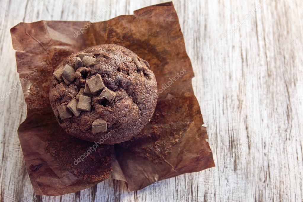 chocolate muffin on white wooden background