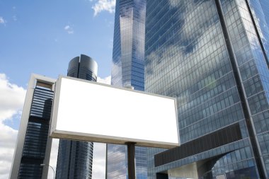 Blank billboard in front of office skyscraper clipart