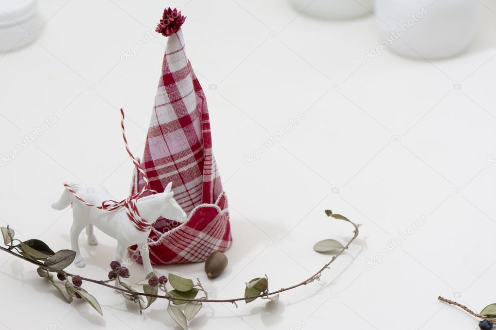 Red and white napkin folded,  forming a Christmas tree