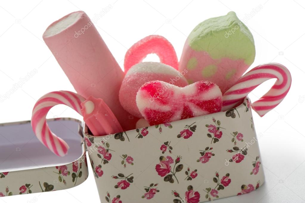 box of mixed colorful pink candy on white background, kids holid