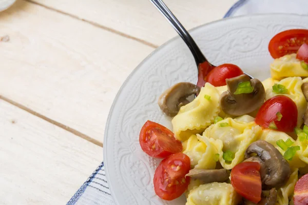 Homemade tortellini stuffed with mushrooms and spring onion and — Stock Photo, Image