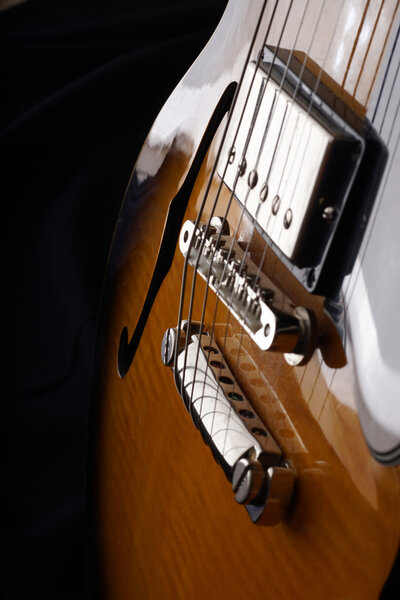 Closeup of old six-string electric guitar. Detail, selective focus.