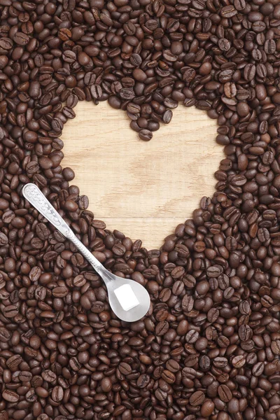 Caffe edition, coffee beans on a wooden background — Stock Photo, Image