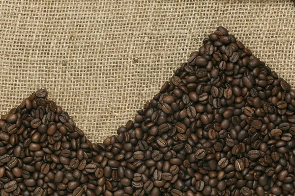 Caffe edition, kaffebönor på Jute bakgrund — Stockfoto