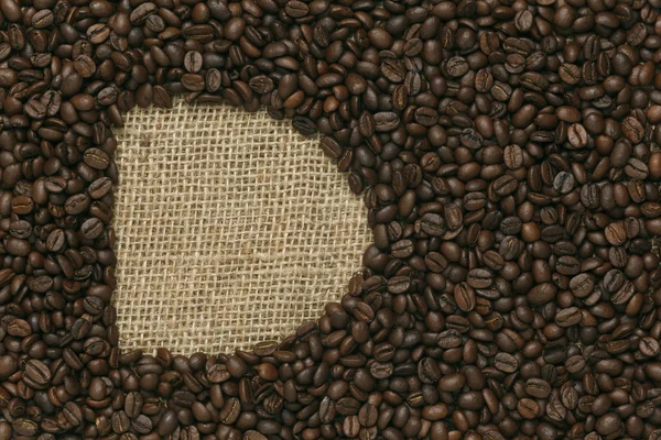 Caffe edition, kaffebönor på Jute bakgrund — Stockfoto