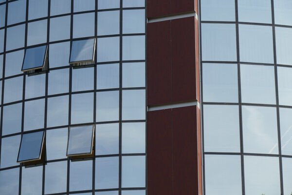 Reflection in windows of modern office building