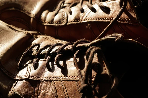 Deel van de oude schoenen met veters op houten vloer — Stockfoto