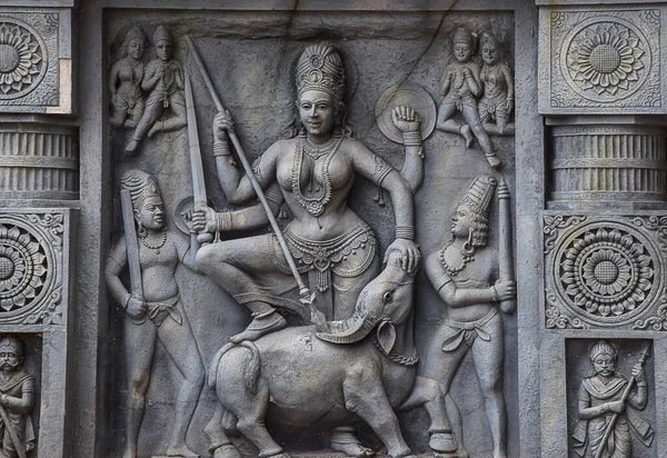 Stock photo of intricate sculpture of Indian goddess Parvati, carved out of stone in ancient hindu temple at Kolhapur city Maharashtra India. focus on object.
