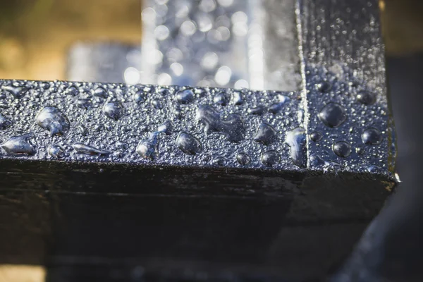 Water drops on a black surface — Stock Photo, Image