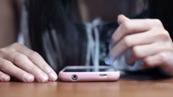 Soft focused young girl browsing smartphone — Stock Video