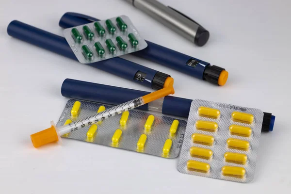 Insulin syringe, insulin injectable pen, tablets. The concept of diabetes treatment.