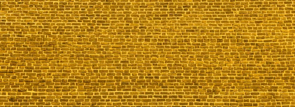 Tuğla duvar, altın rengi duvarlardan geniş bir manzara. Küçük tuğlalı duvar. Sancak 2021 modasına uygun olarak ayarlandı. Web ya da grafik sanat projeleri için modern duvar kağıdı tasarımı. Soyut şablon ya da maket.