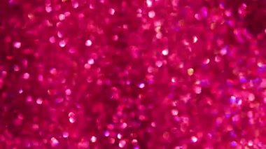 Parlak Pembe Parıltı ve Parlak Arkaplan. 4K çözünürlüğü. Pembe parıltılı arka plan, ışıl ışıl. Yakut parlayan ışık, yıldızlar pullar kıvılcımlar ve parlak folyo arka plan
