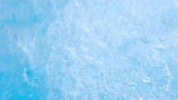 Sparkling gushing blue transparent water in hot tub or swimming pool. Slow motion full HD resolution video. Decorative jet or fountain of water in the hot tub — Stock Video