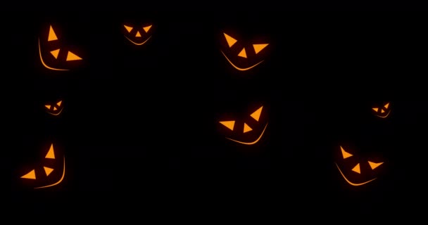 Narancs ijesztő tök arcok jelennek meg a fekete háttérben. Halloween koncepció. 4k felbontású animáció. — Stock videók
