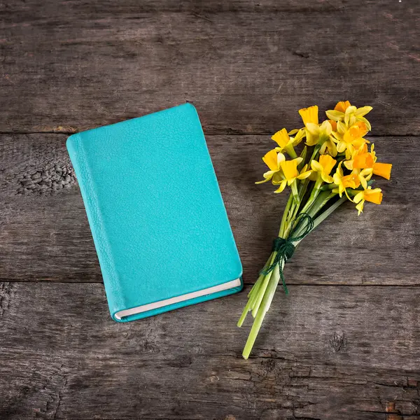 Narcisos amarillos y cuaderno —  Fotos de Stock