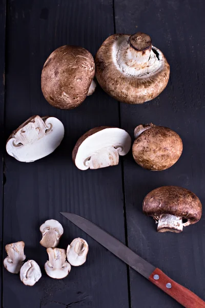 Fresh mushrooms  on a black board. — Stock Photo, Image