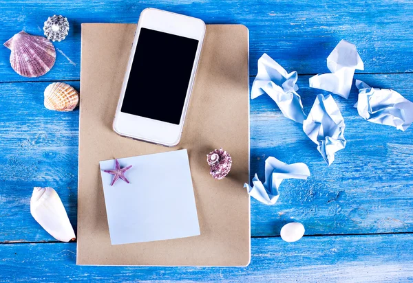 shells, notebook and mobile phone,