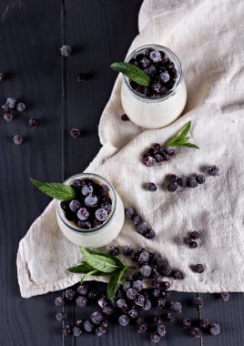 natural yoghurt with a black currant. clipart