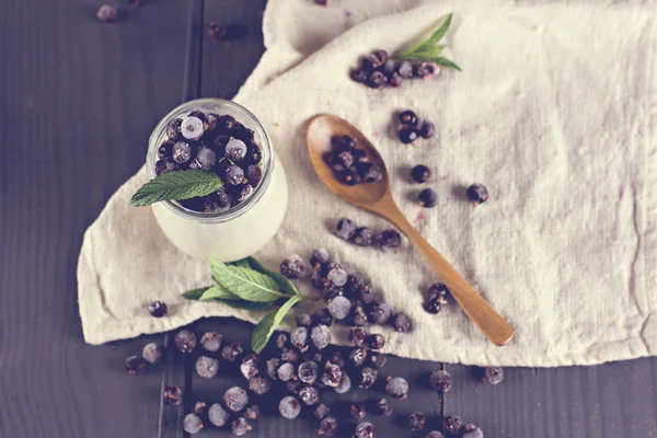 Natural yoghurt with a black currant — Stock Photo, Image