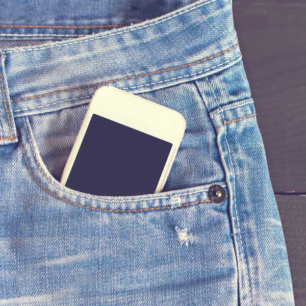 Jeans and mobile phone — Stock Photo, Image