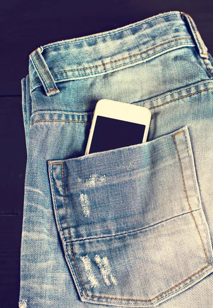 Jeans and mobile phone — Stock Photo, Image