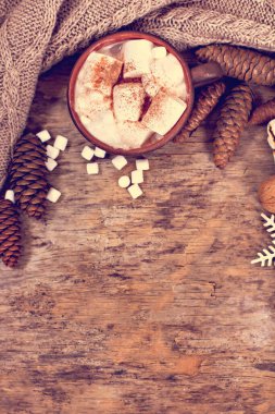 Kakao, kahve, hediye, köknar dalı, fındık, koni, sıcak örgü battaniye. Noel kurabiyeleri Bir kadının eli bardağı tutar.