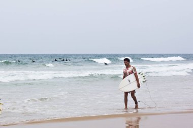 Tel Aviv, İsrail, Kasım 2019 - Sörfçü, denizdeki sörfçüler su bekliyor. Denizde sörfçü